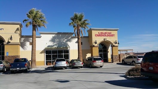 Front of the cardiology office with palm trees and parking.